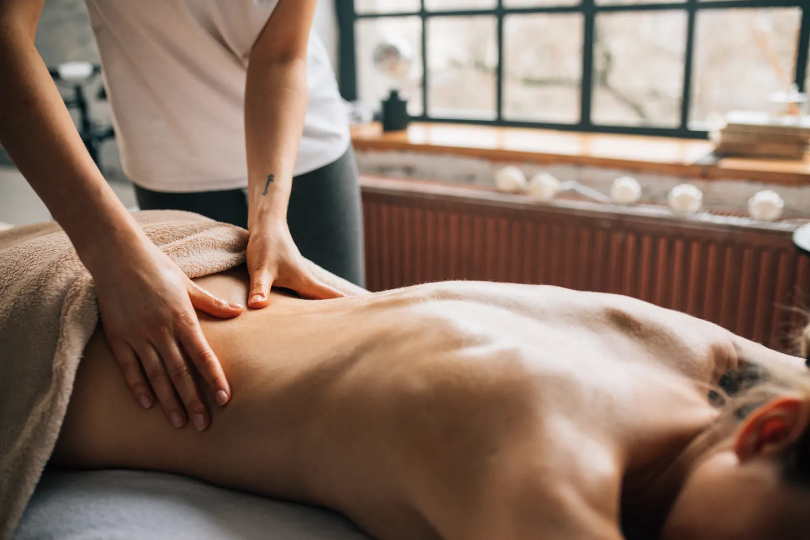 Soothing massage session in a warm, relaxing indoor spa setting